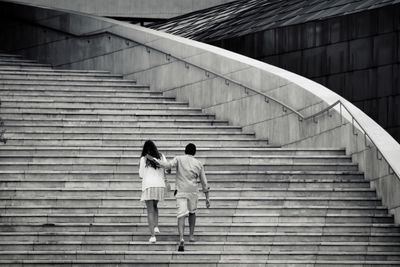 Couple walking on staircase