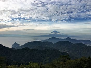 Scenic view of mountains against cloudy sky