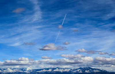 Low angle view of vapor trail against blue sky