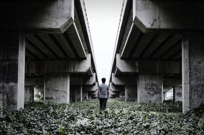Woman standing against built structure