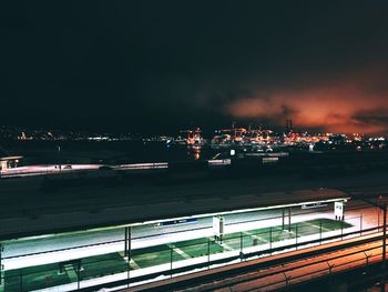 Illuminated cityscape against sky at night