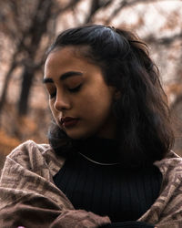 Close-up of young woman looking away