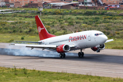 Side view of airplane on runway