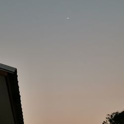 Low angle view of building against clear sky at night