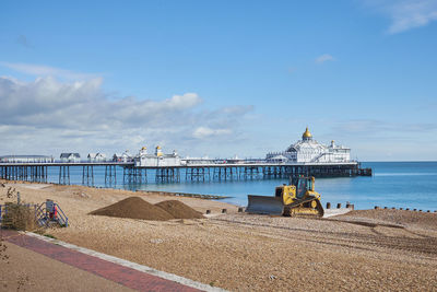 Construction vehicle carrying out coastal defence and beach replenishment. eastbourne, east sussex. 