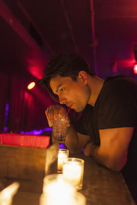 Young man enjoying a drink at a bar
