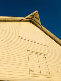 Low angle view of building against clear blue sky