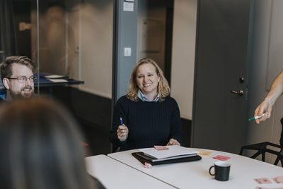 Smiling woman talking during business meeting