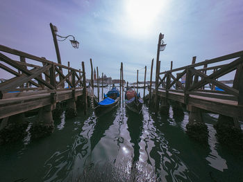 View of pier in canal against sky