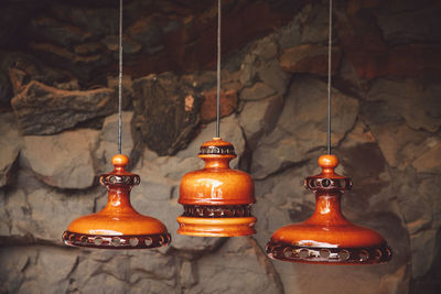 Close-up of decoration hanging against stone wall