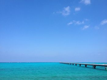 Scenic view of sea against clear blue sky