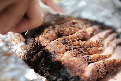Close-up of hand holding meat