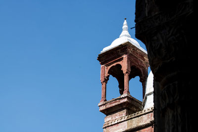 Low angle view of historical building against clear blue sky