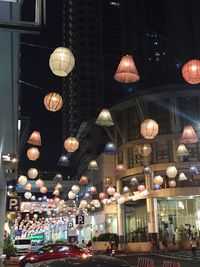 Illuminated street light and buildings in city at night