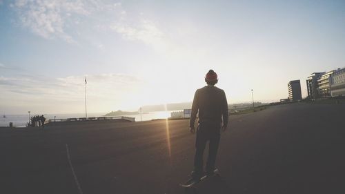 Full length of woman standing against sky