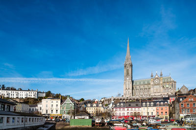 View of church in city against blue sky