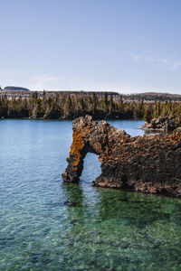 Scenic view of sea and rocks against sky