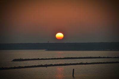 Scenic view of sea against orange sky