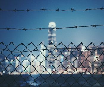 Chainlink fence against cloudy sky