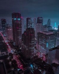 High angle view of illuminated modern buildings in city at night