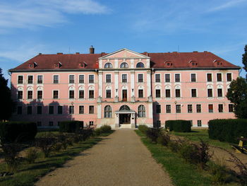 Houses by building against sky