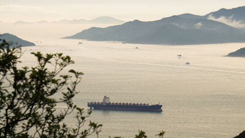 Scenic view of sea and mountains against sky