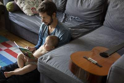 Father reading book to baby