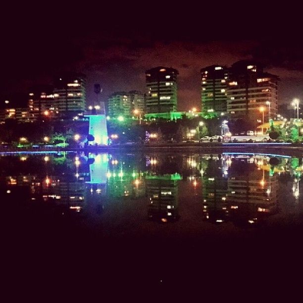 night, illuminated, building exterior, city, architecture, built structure, skyscraper, cityscape, reflection, water, modern, office building, urban skyline, building, city life, waterfront, river, tower, tall - high, outdoors