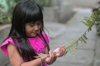 Girl holding plant