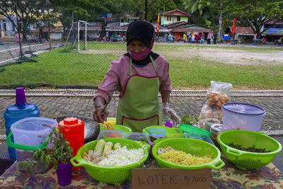 Full length of woman having food on table