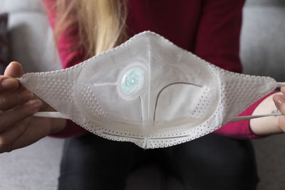 Close-up of woman holding hat