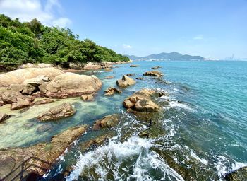 Scenic view of rocks in sea against sky