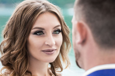 Close-up of woman looking at man outdoors