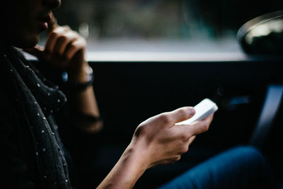 Close-up of man using mobile phone