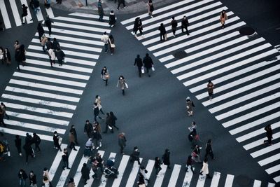 High angle view of people walking on road