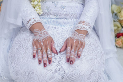 Midsection of bride with henna tattoo