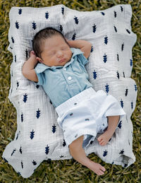 High angle view of baby lying on bed