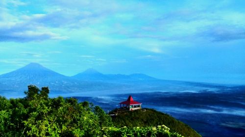 Scenic view of mountains against blue sky