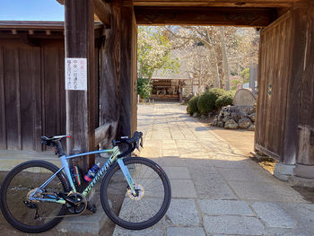 Bicycle parked on footpath by building