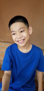 Close-up of smiling boy at home