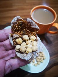Close-up of hand holding coffee cup