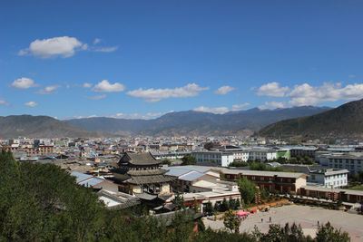 High angle view of buildings in town against sky