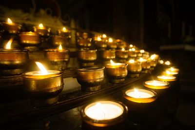 Lit tea light candles in church