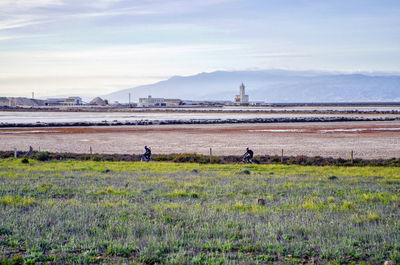 Scenic view of salt field against sky and cycling n cabo de gata nijar, almería, spain