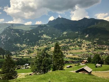 Scenic view of landscape and buildings against sky