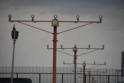 Low angle view of street lights against sky