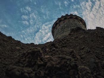 Low angle view of monument against cloudy sky