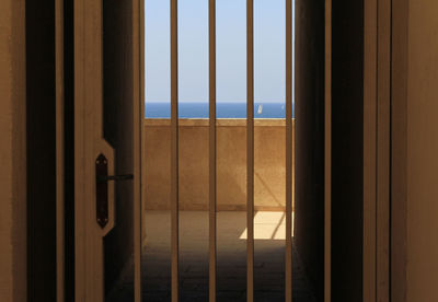 The sea can be seen through metal bars a house entrance in tel aviv, israel
