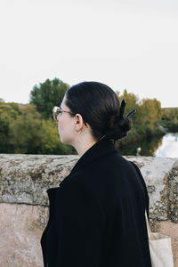Side view of man looking through window