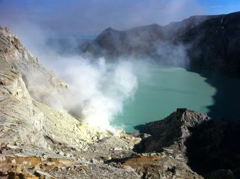 Steam emerging from volcanic landscape